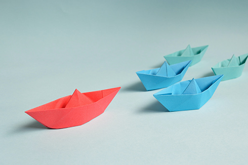 Paper boats in a line