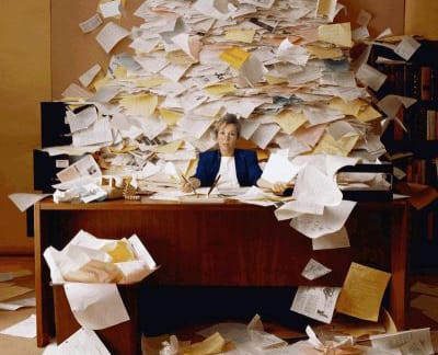 Woman with desk of papers