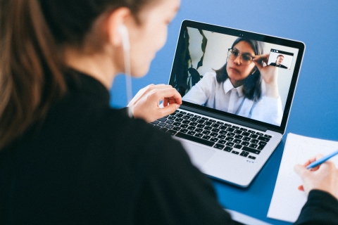 Business woman having a video call with cowork
